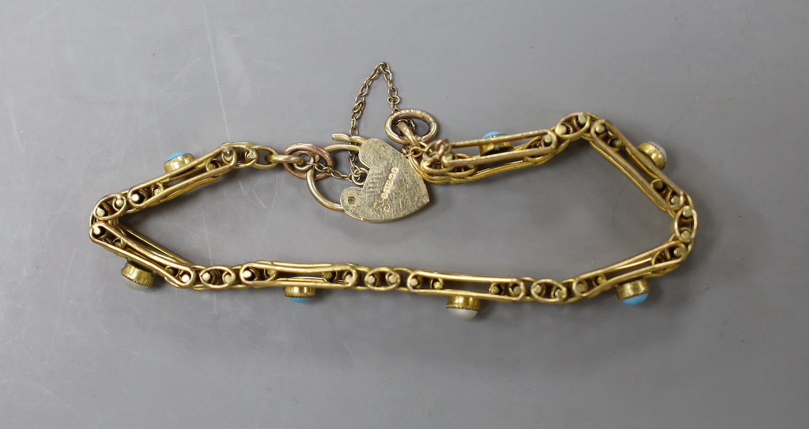 A 9ct gold , split pearl and turquoise set gate link bracelet, 17.5cm, gross weight 17.4 grams.